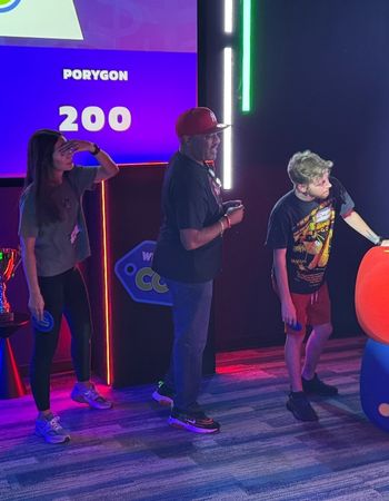 LeadVision employees looking playing on a gameshow set for a team bonding outing