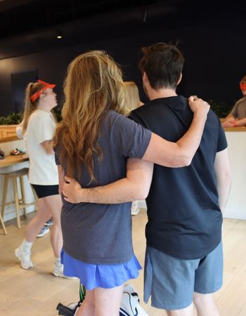 2 LeadVision employees hugging after winning pickleball