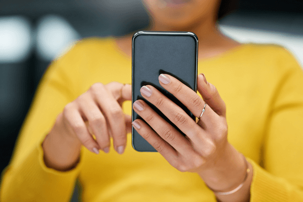 close up of woman holding a phone up